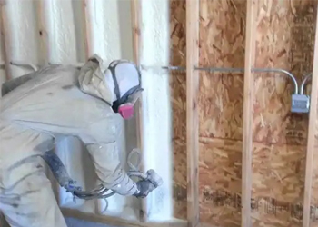 Sunny South Inc employee spraying foam insulation
