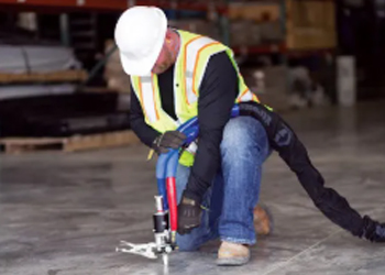 man drilling into concrete