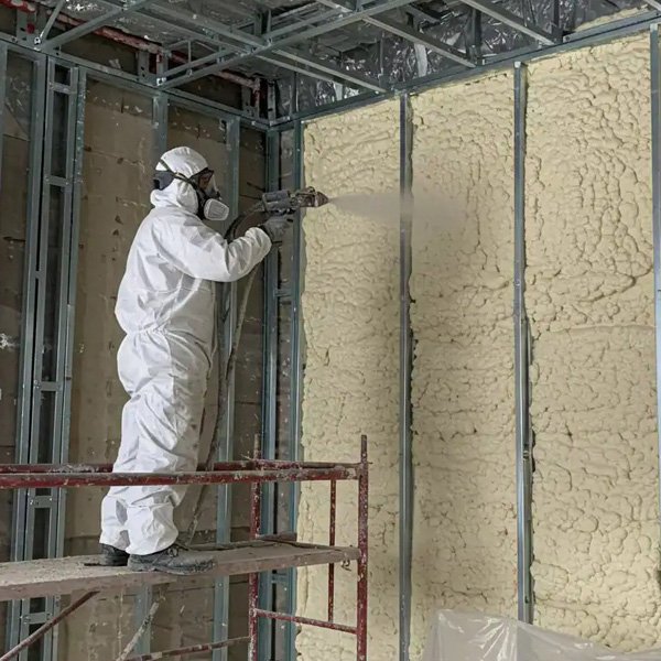 Commercial building interior with insulation installed between studs in Calgary, AB