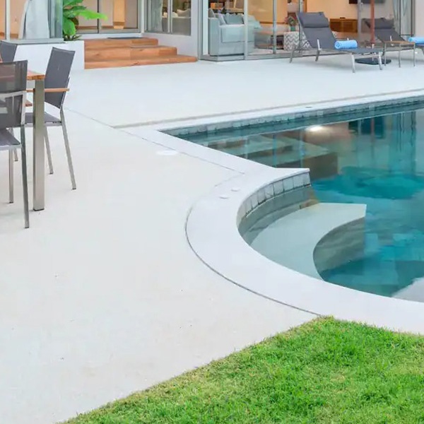 Backyard pool area with surrounding deck and outdoor features in Calgary, AB