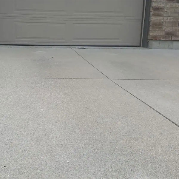 A concrete driveway crack near the garage door in Calgary, AB