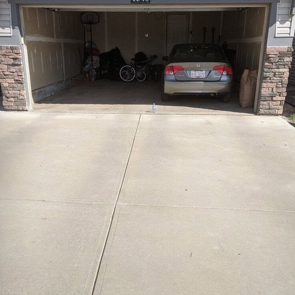 A garage space and concrete driveway after leveling by Sunny South Insulators in Calgary, AB